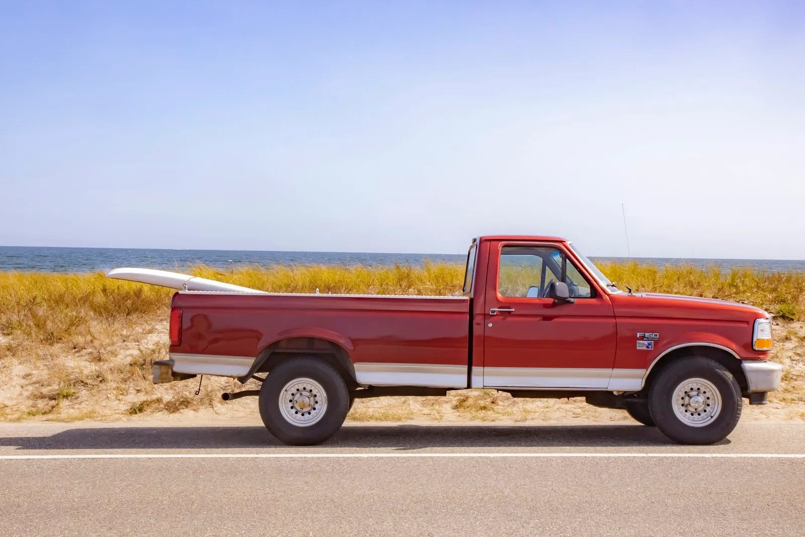 A used pickup truck parked by the beach